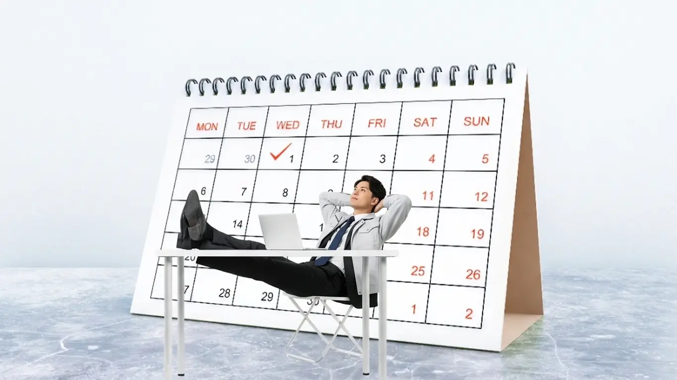 カレンダーの前で休みについて悩む施工管理